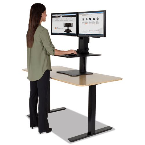 Woman standing an ergonomic sit/stand desk